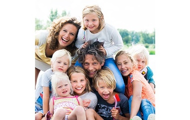 Man surrounded by his children and wife