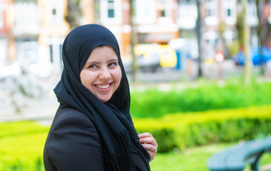 Women in hijab smiling and looking at the camera
