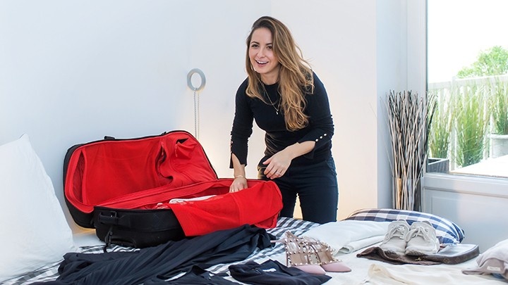Woman packing her things in luggage