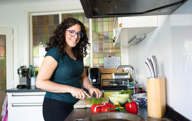 woman cutting vegetables in kitchen