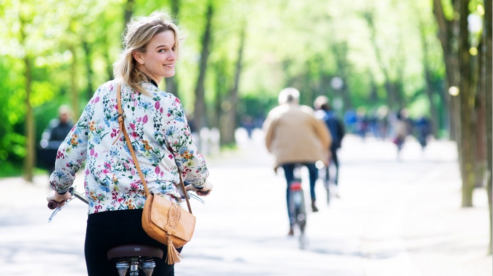 Blond woman biking and looking back