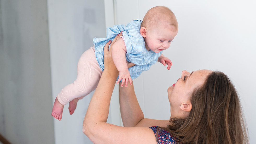 Woman lifting her baby