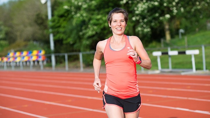 Woman in running attire running to the camera