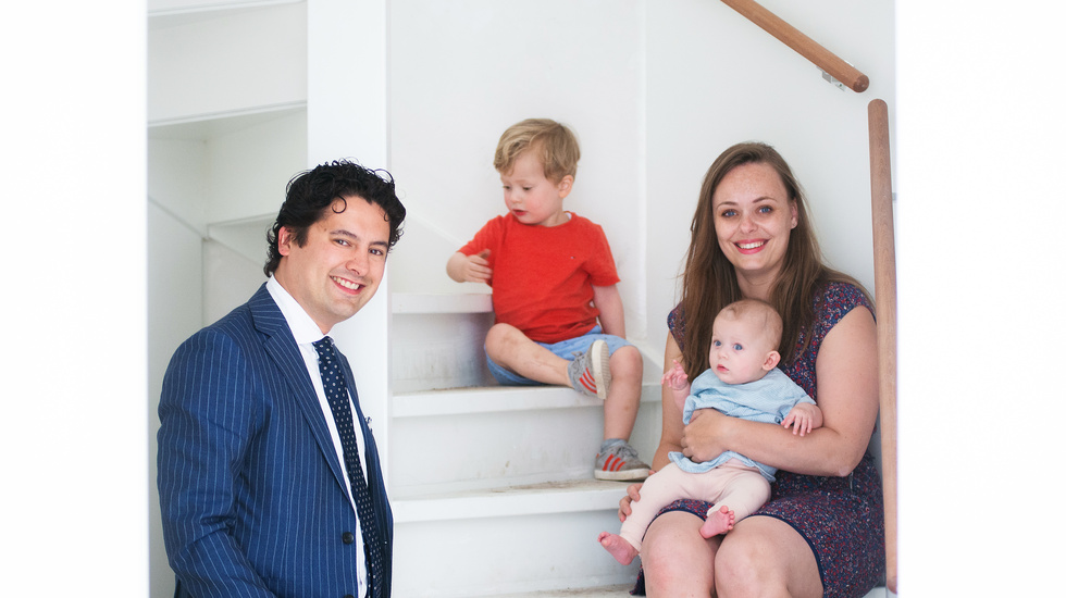 Man, woman and two children sitting in the staircase