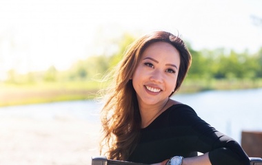 Asian woman posing by the lake