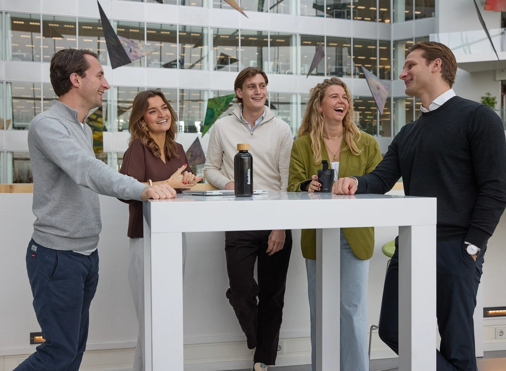 Picture of three men and two women standing together.