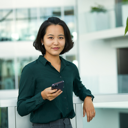 Picture of a woman holding her mobile phone.