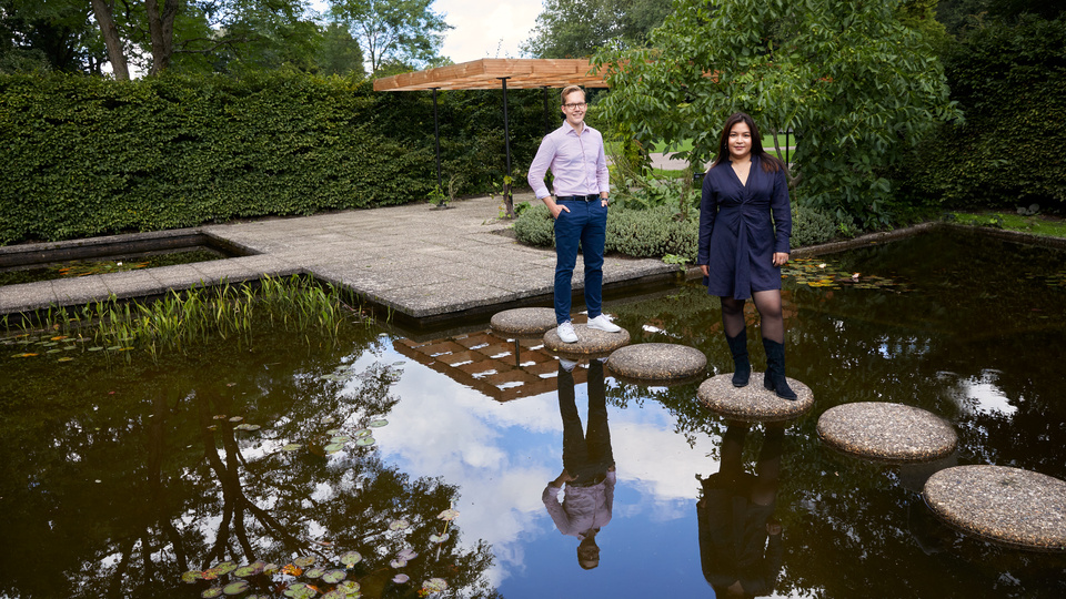 A picture of a man and a woman near a pond.