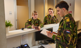 desk with 3 people